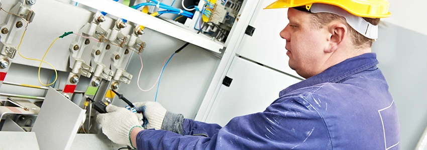 Person wearing gloves working on an electrical box as part of a HSS Training electrical course